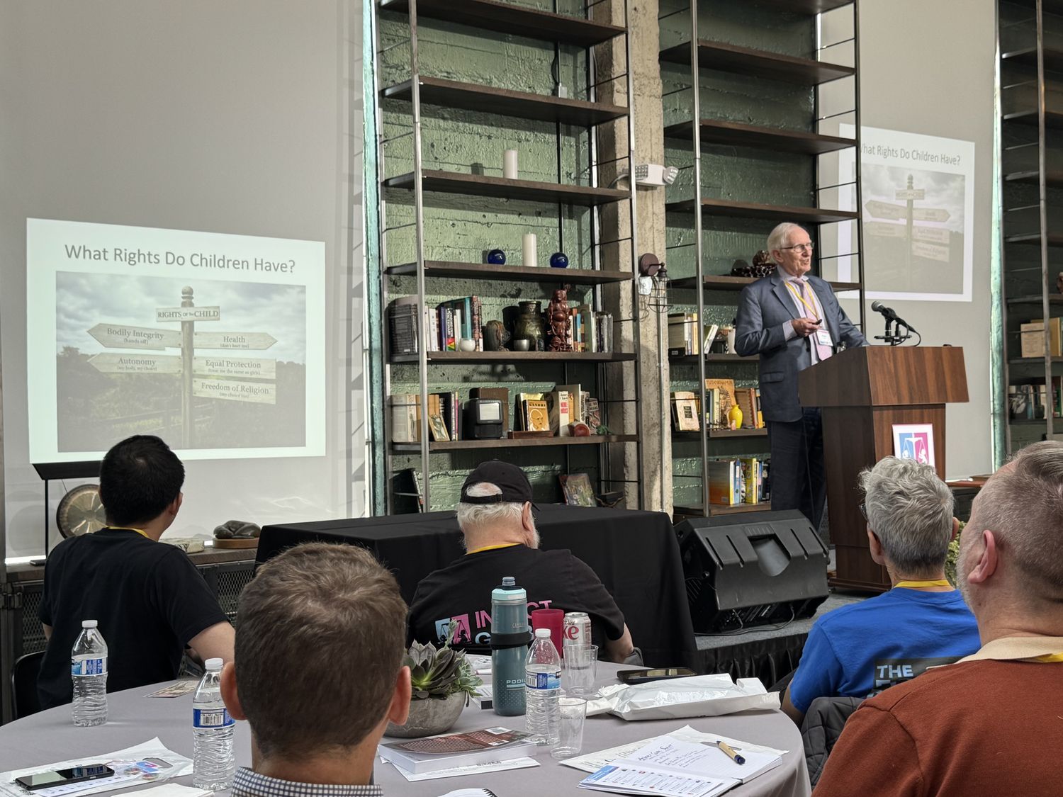 Speaker presenting from a podium inside the downtown Los Angeles venue