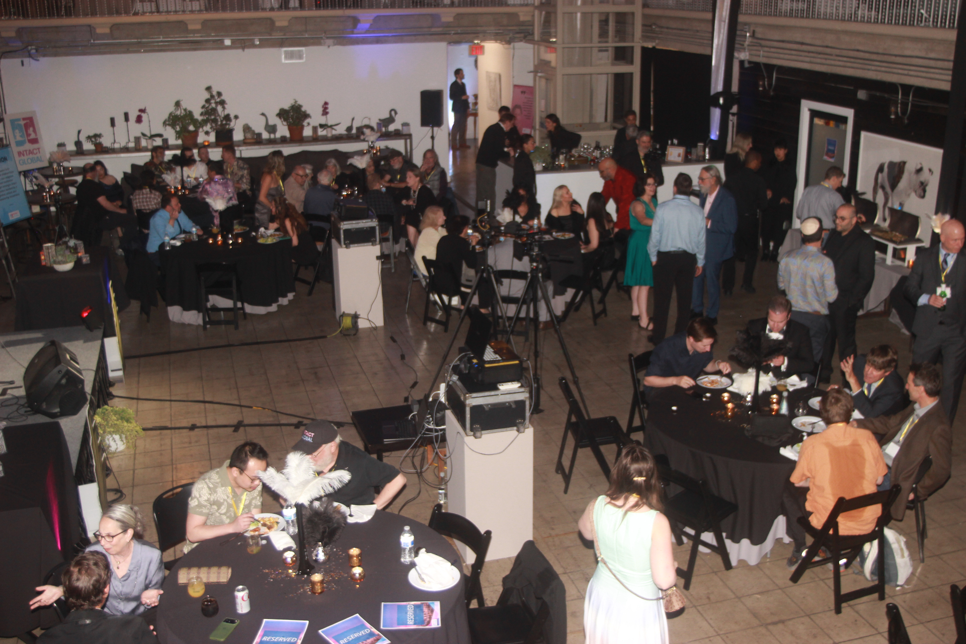 Guests networking during a conference reception inside Historic Dancehall