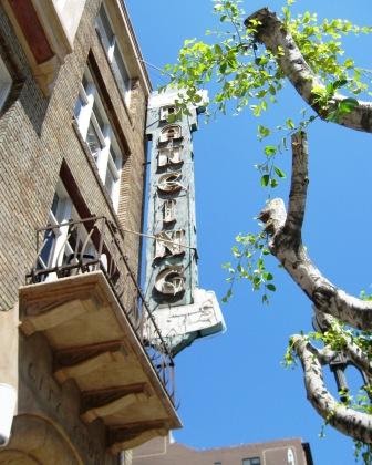 The vertical Dancing Girls sign on Spring Street, seen from the sidewalk below